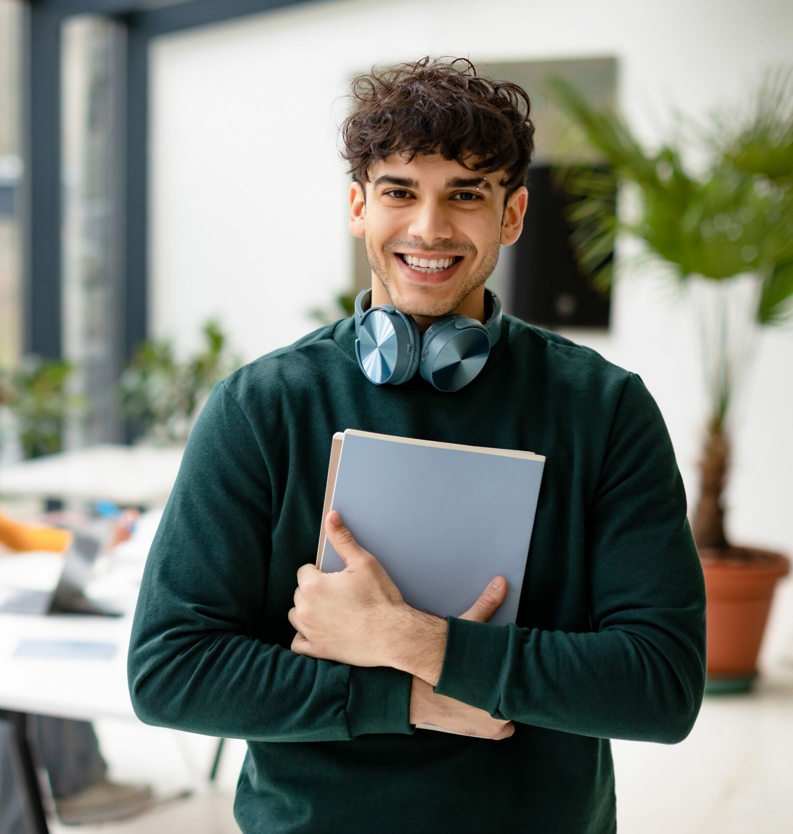 European,Man,College,Student,Holding,Books,And,Smiling,At,Camera